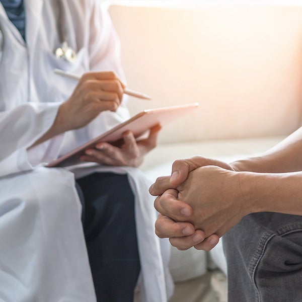 Provider taking notes with patient