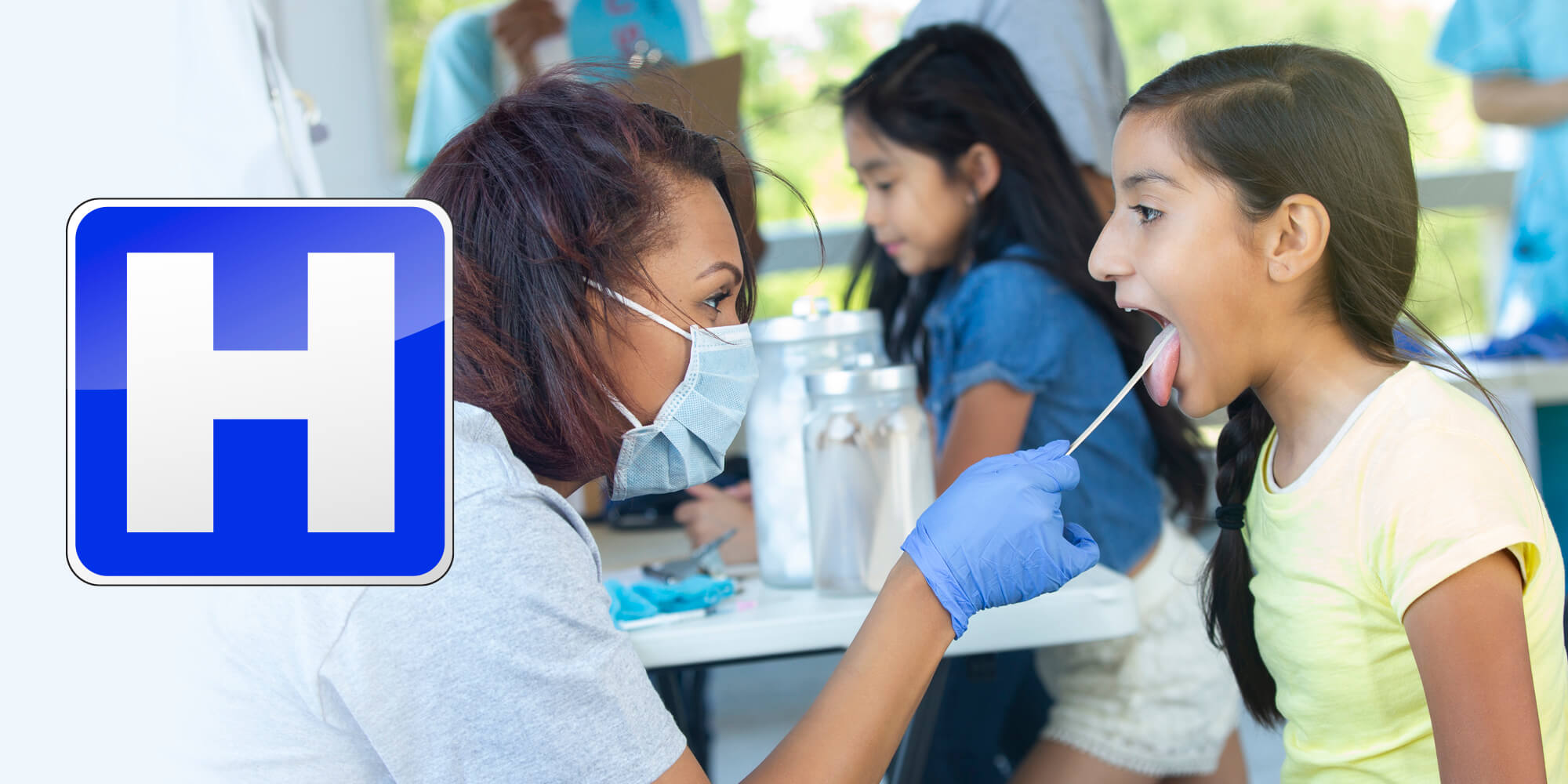 Masked health care worker examining young patient