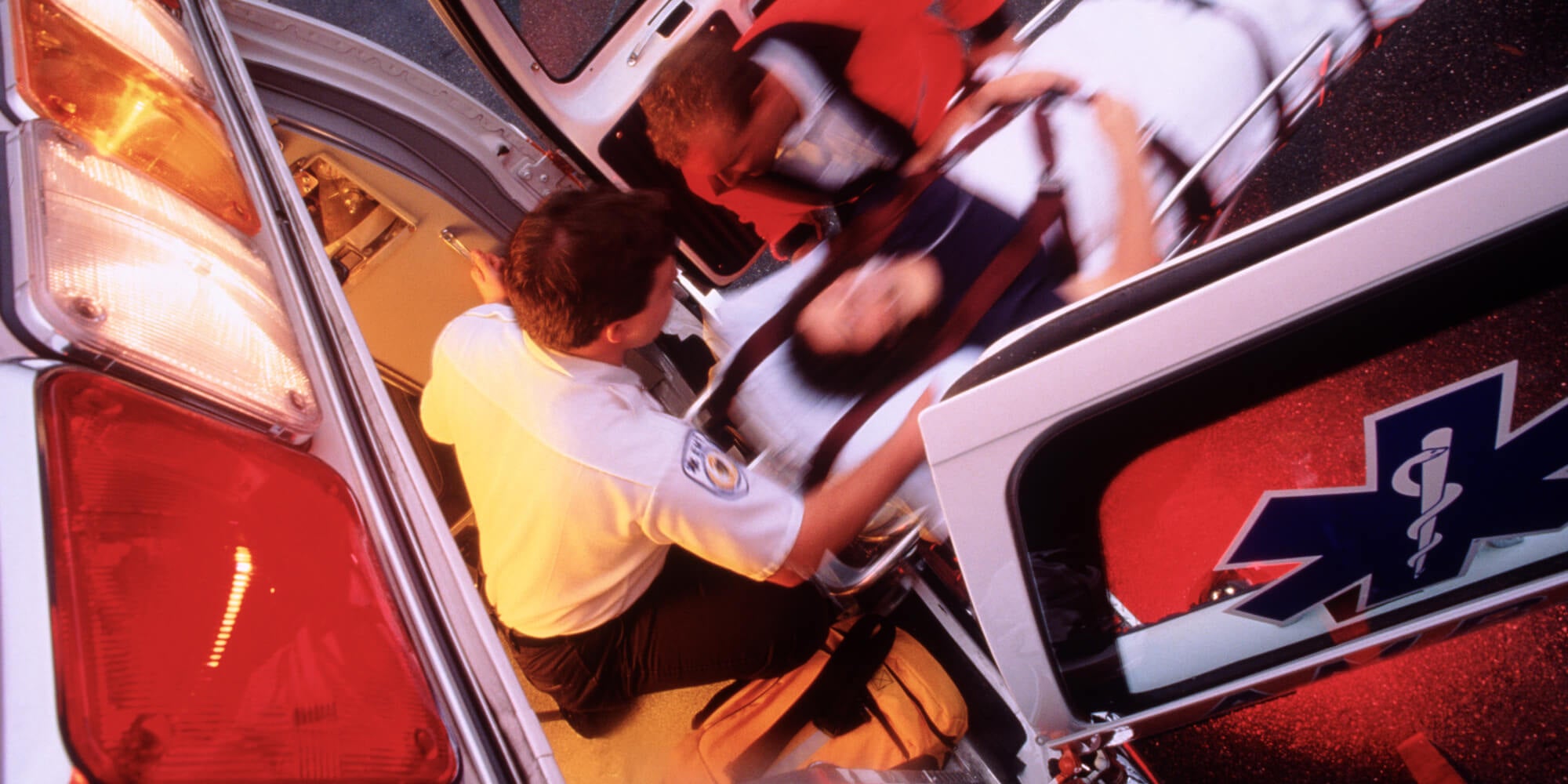 Medical professionals taking a patient out of an ambulance