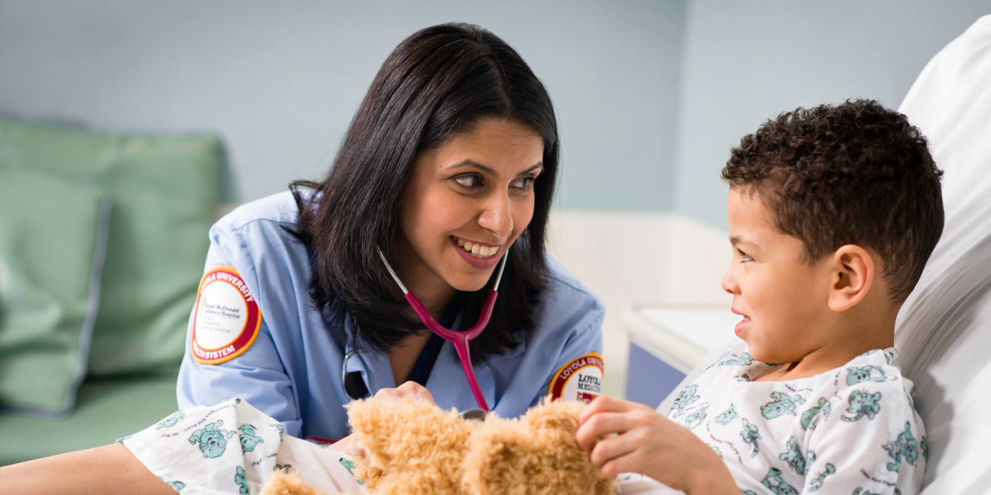 Loyola pediatric physician with younger patient