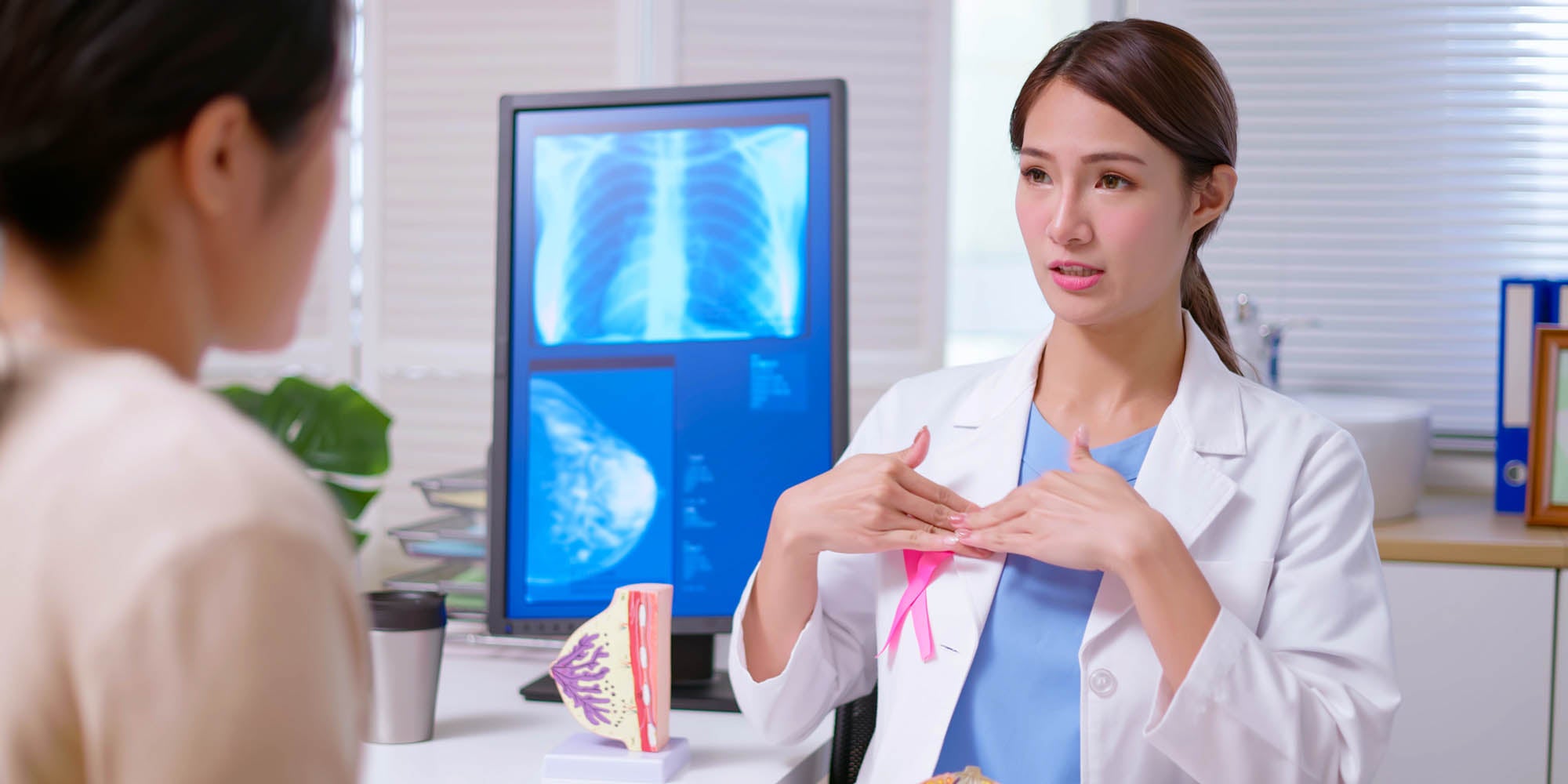 Doctor discussing breast cancer awareness to patient