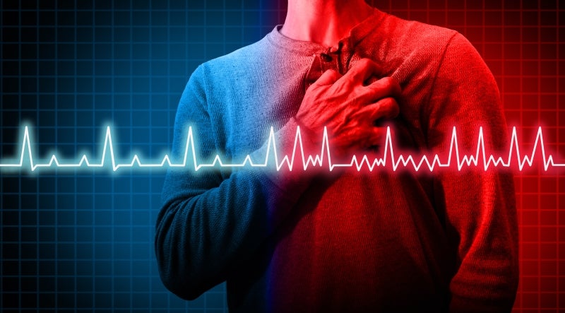 Image showing a man clutching his chest in pain with a heart pulse chart overlay