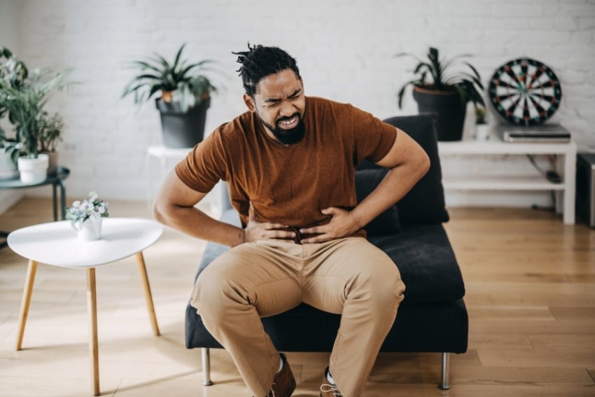 Man experiencing painful symptoms of appendicitis