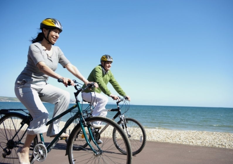 Woman and man riding bikes for exercise