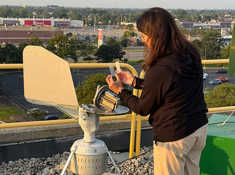 Loyola allergist checks the allergy count on the roof of Gottlieb Memorial Hospital