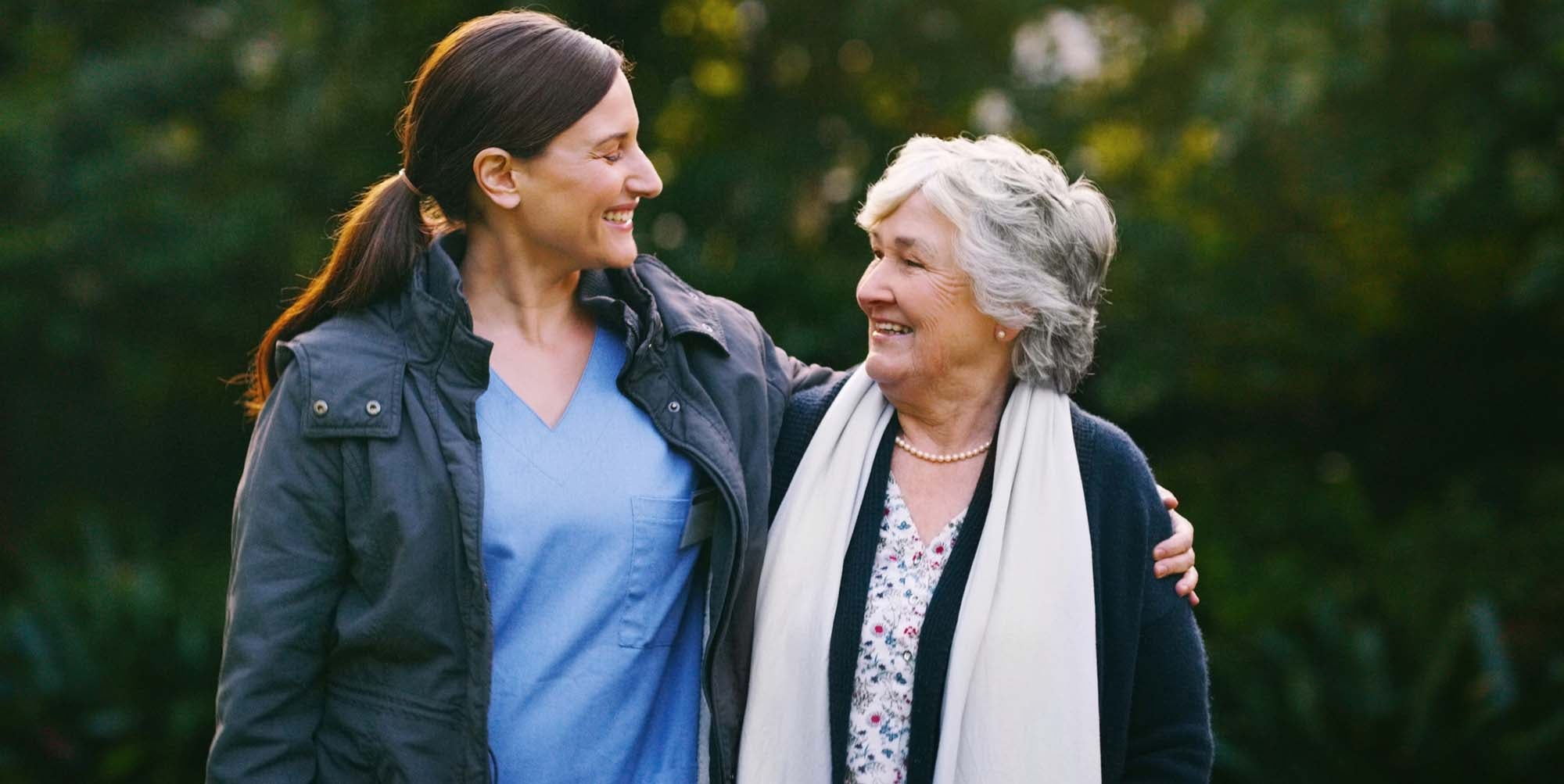 Mother and daughter embracing outside