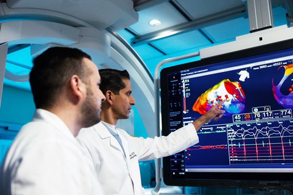 Physicians looking at an MRI of a heart