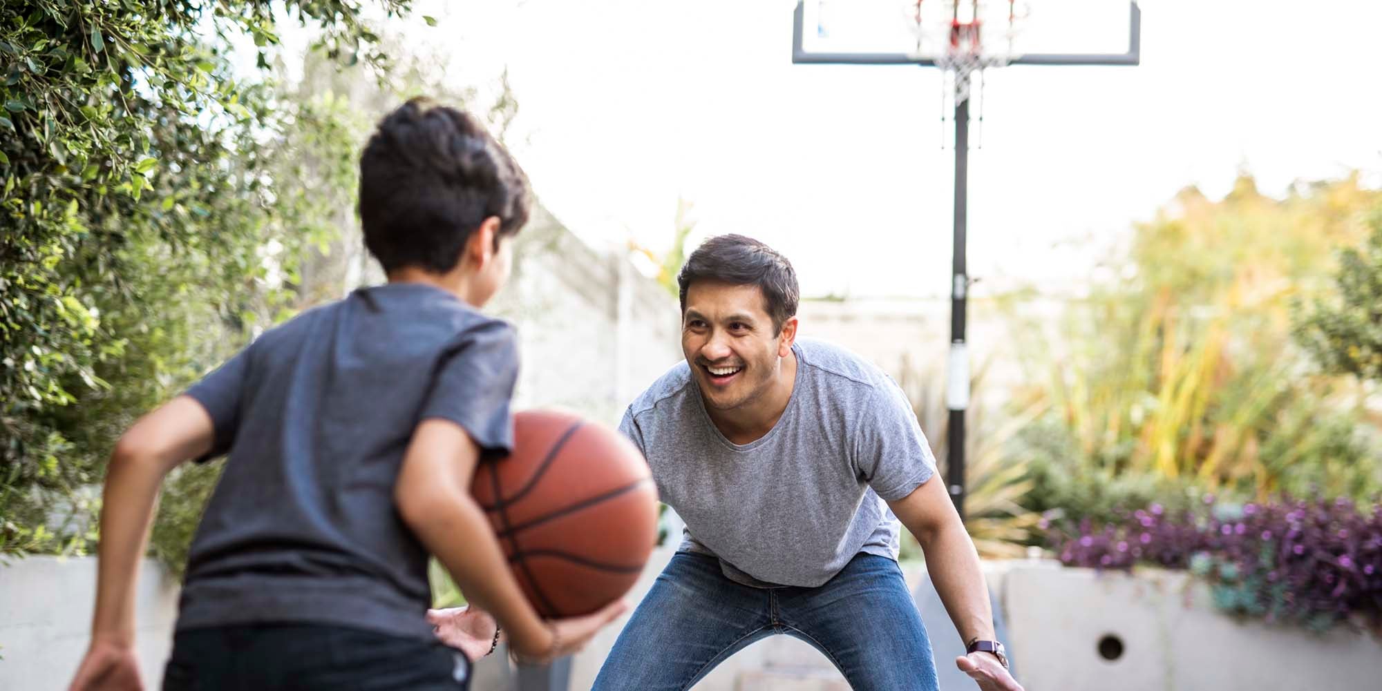 Father and son playing basketball