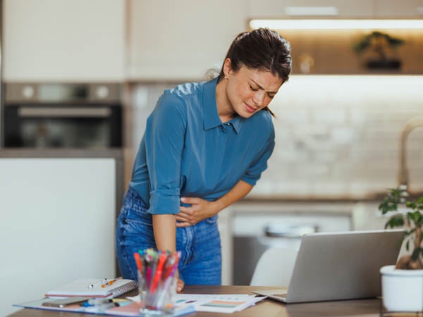 Woman in pain holding her stomach