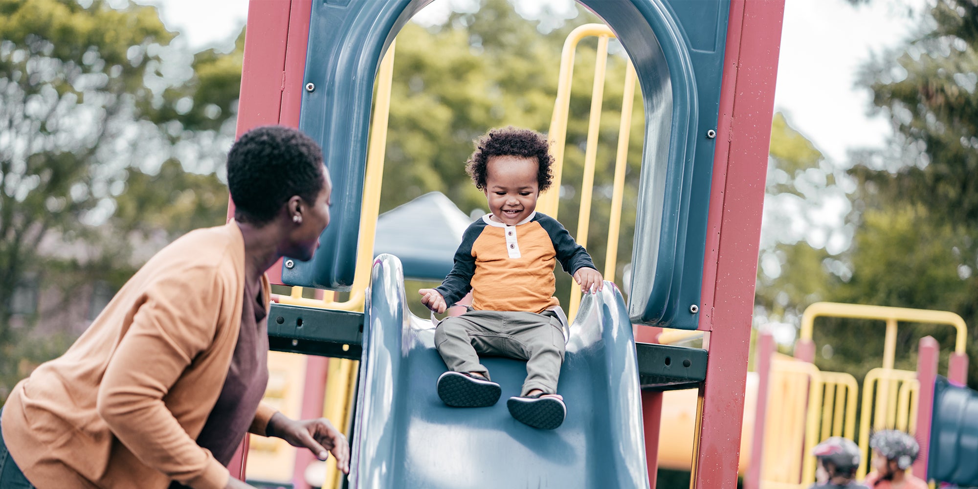 Mother and son playing at a playground