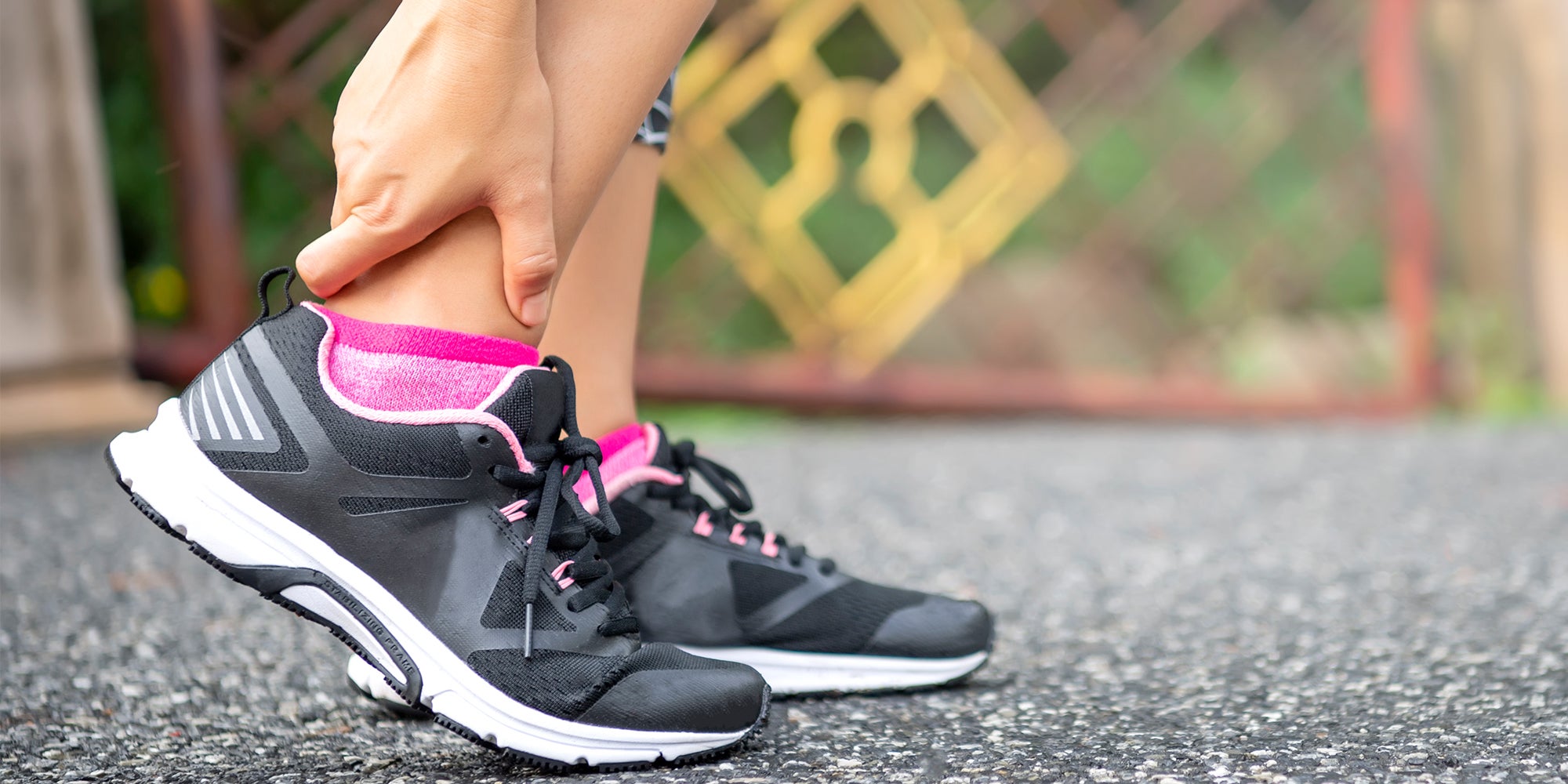 Person holding their heel in pain