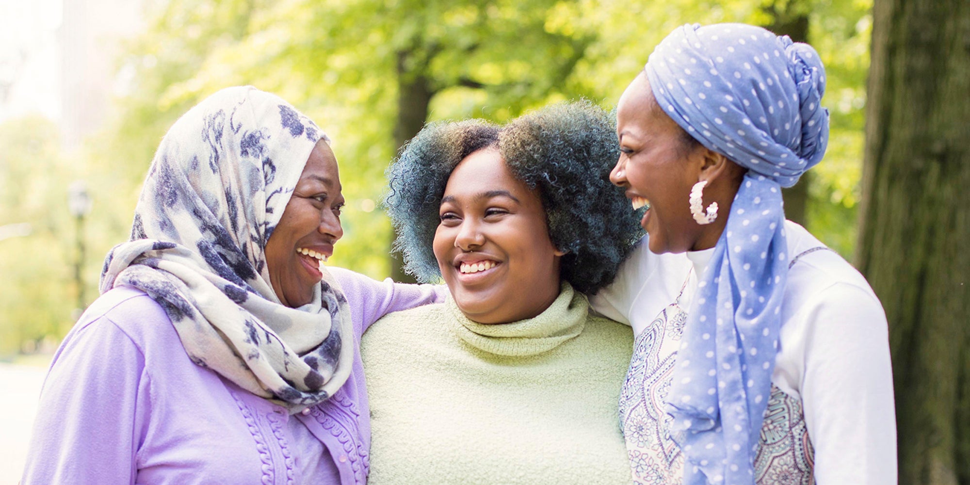 Three women smiling outdoors