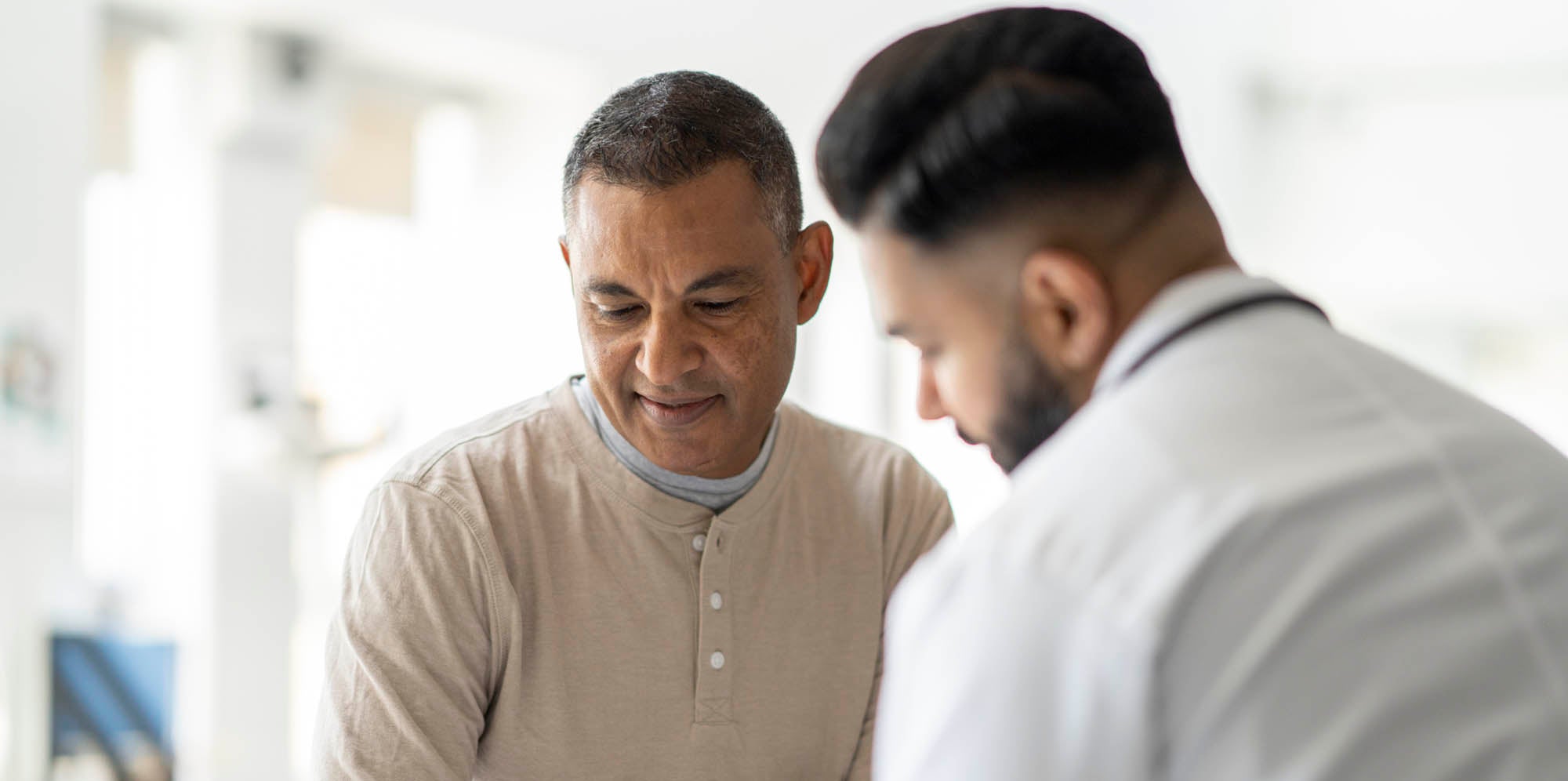 Doctor talking to male patient