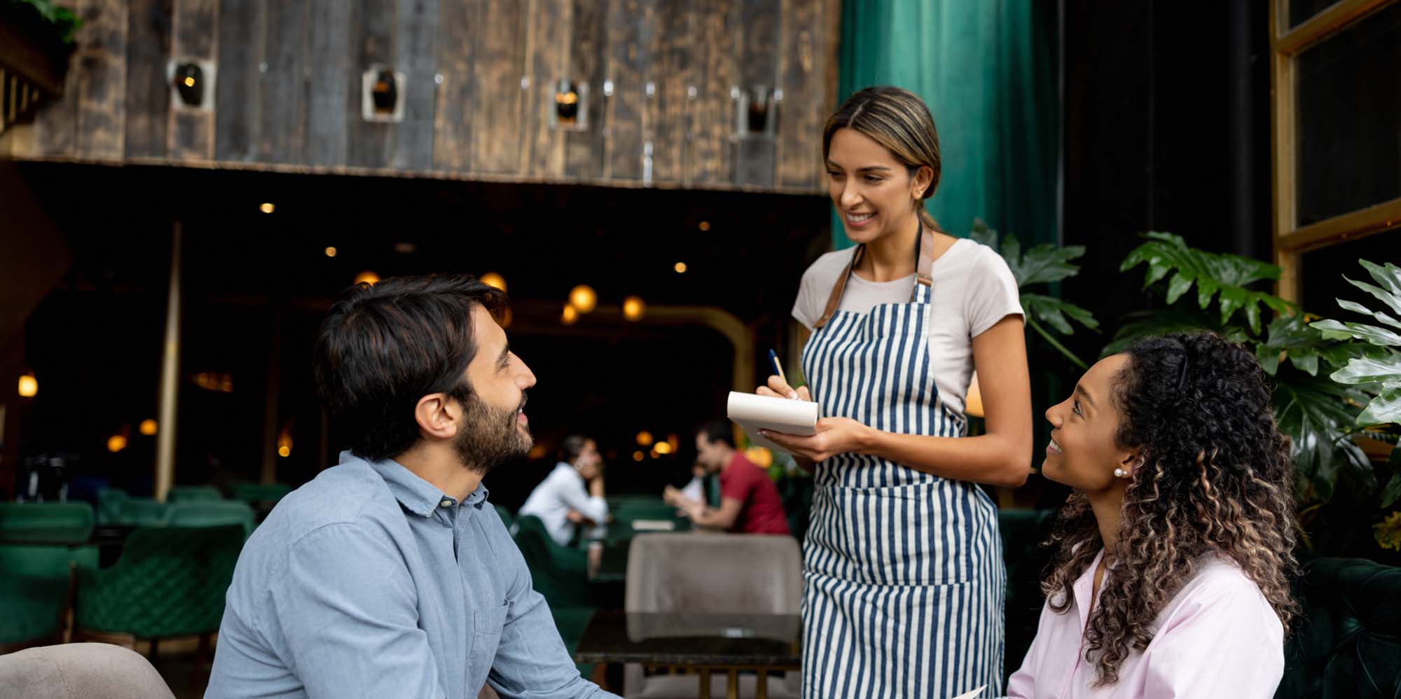 Couple ordering food from waitress