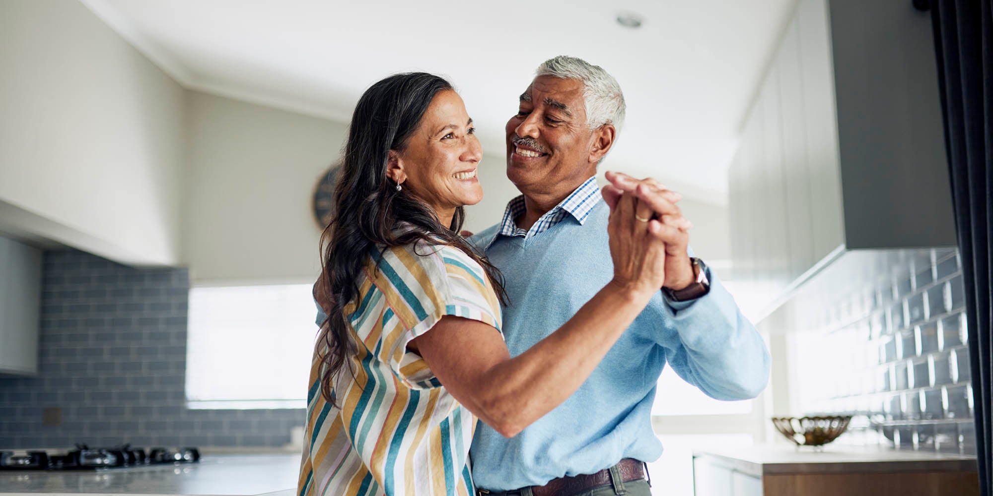 Woman and man dancing in their house
